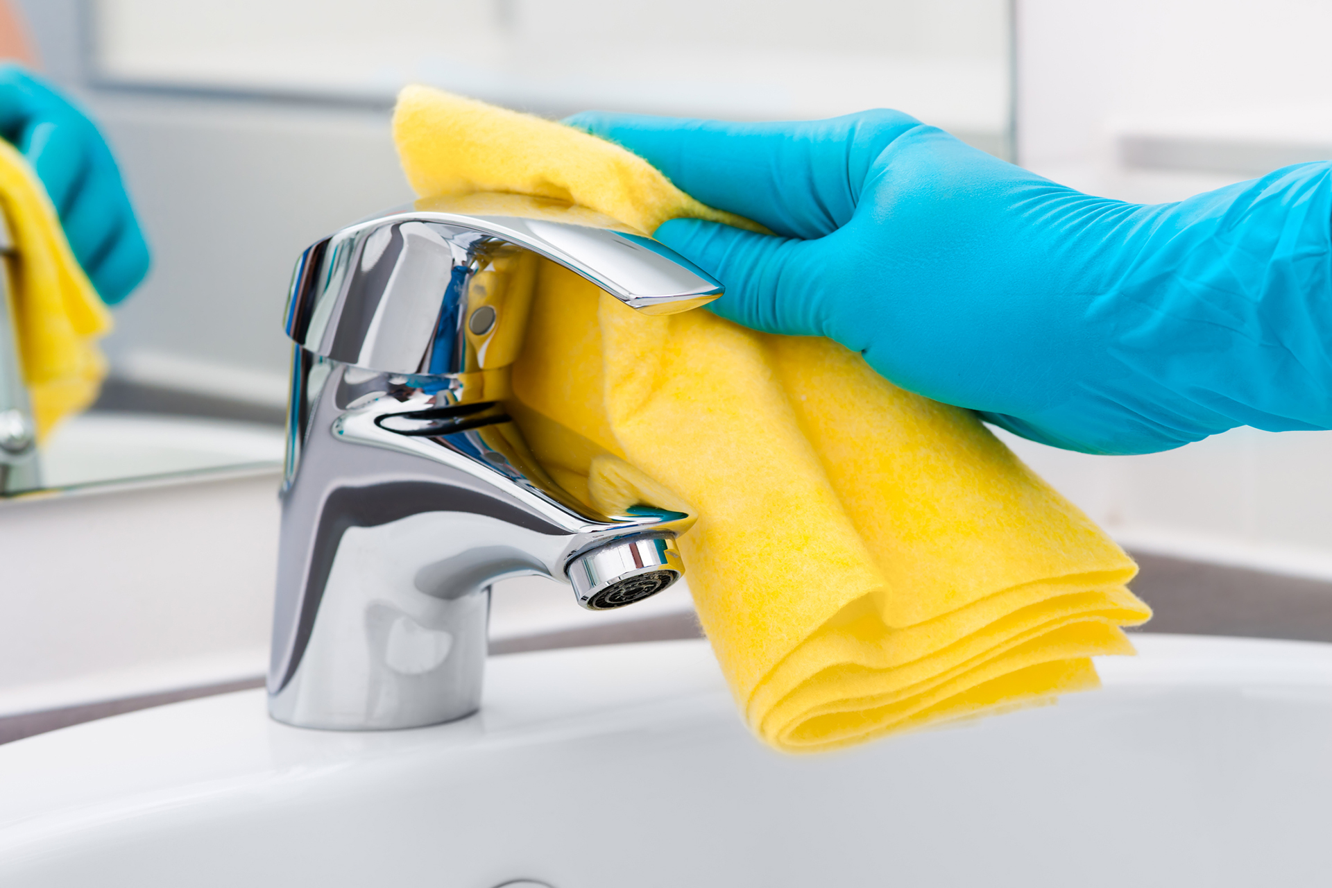Gloved hand cleaning faucet-509278027 Cleaning Contractor