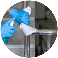 Woman spraying and cleaning handrails